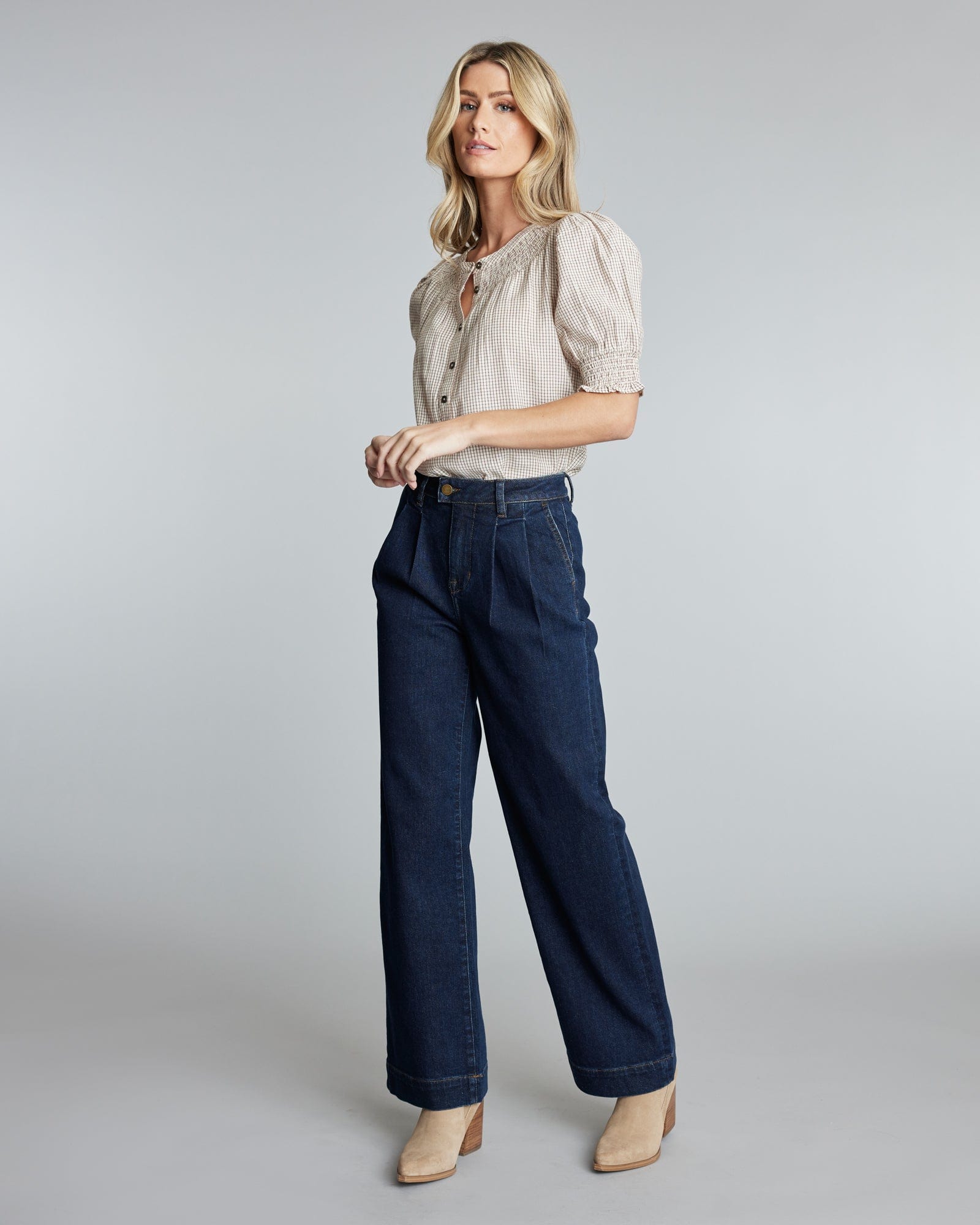 Woman in pleated trouser jeans.