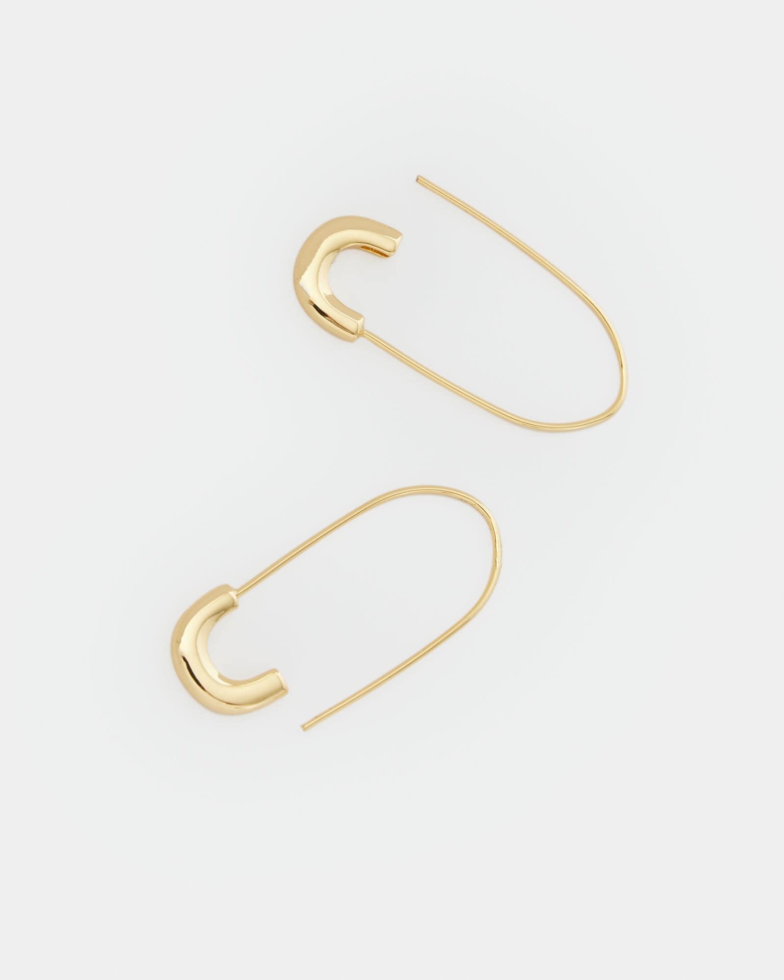 Two gold earrings resembling safety pins