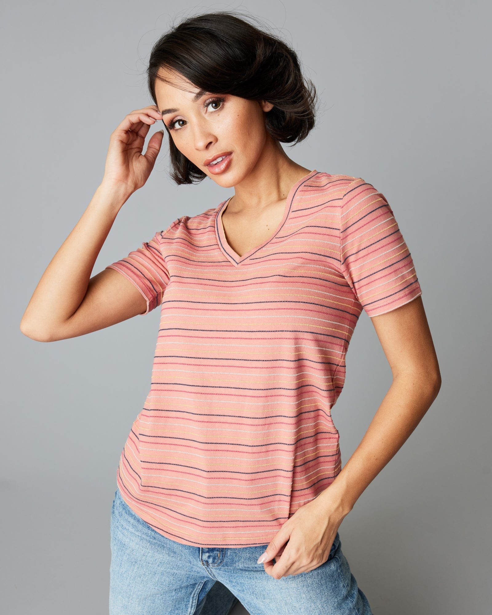 Woman in a short sleeve, pink, striped tee.