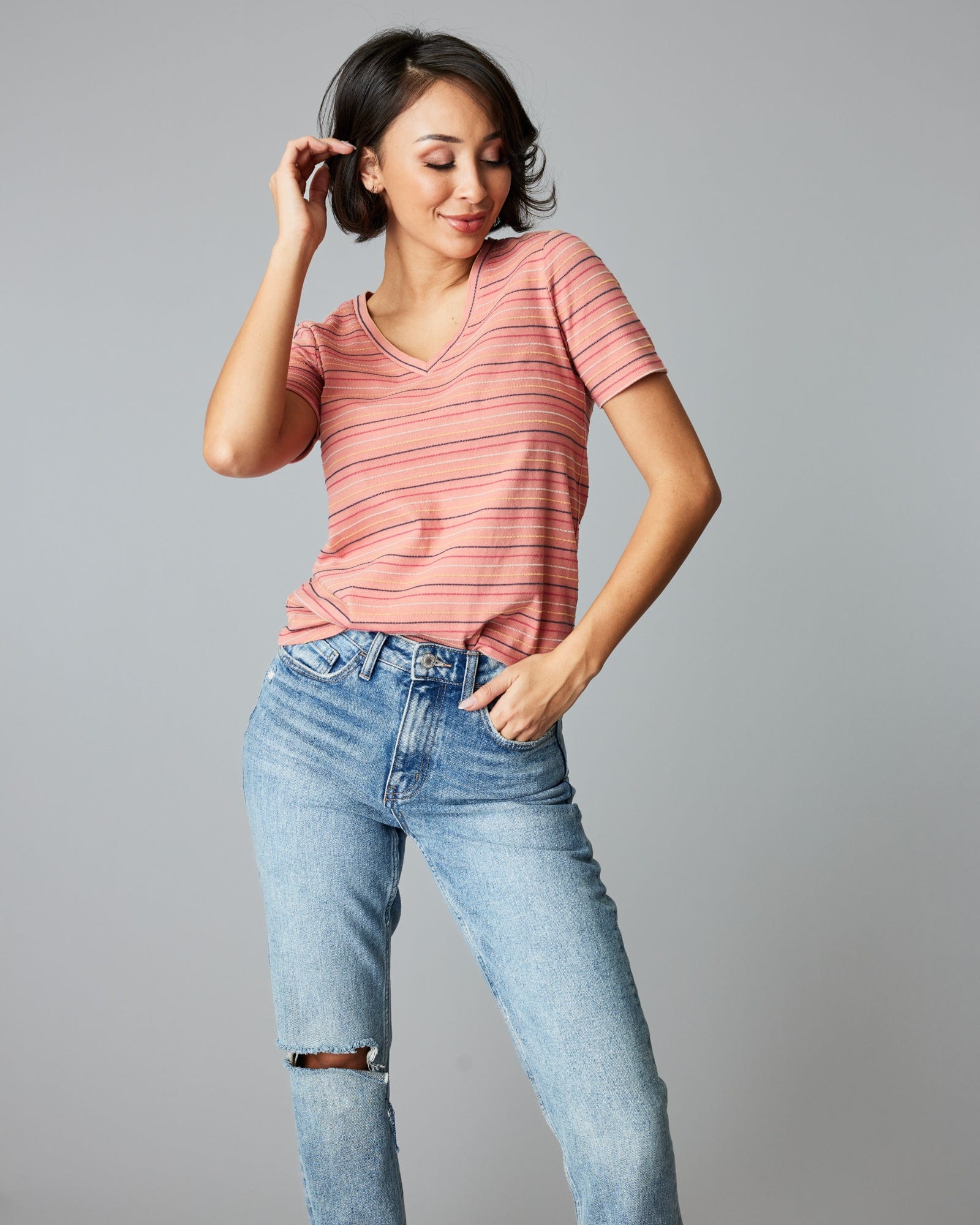 Woman in a short sleeve, pink, striped tee.