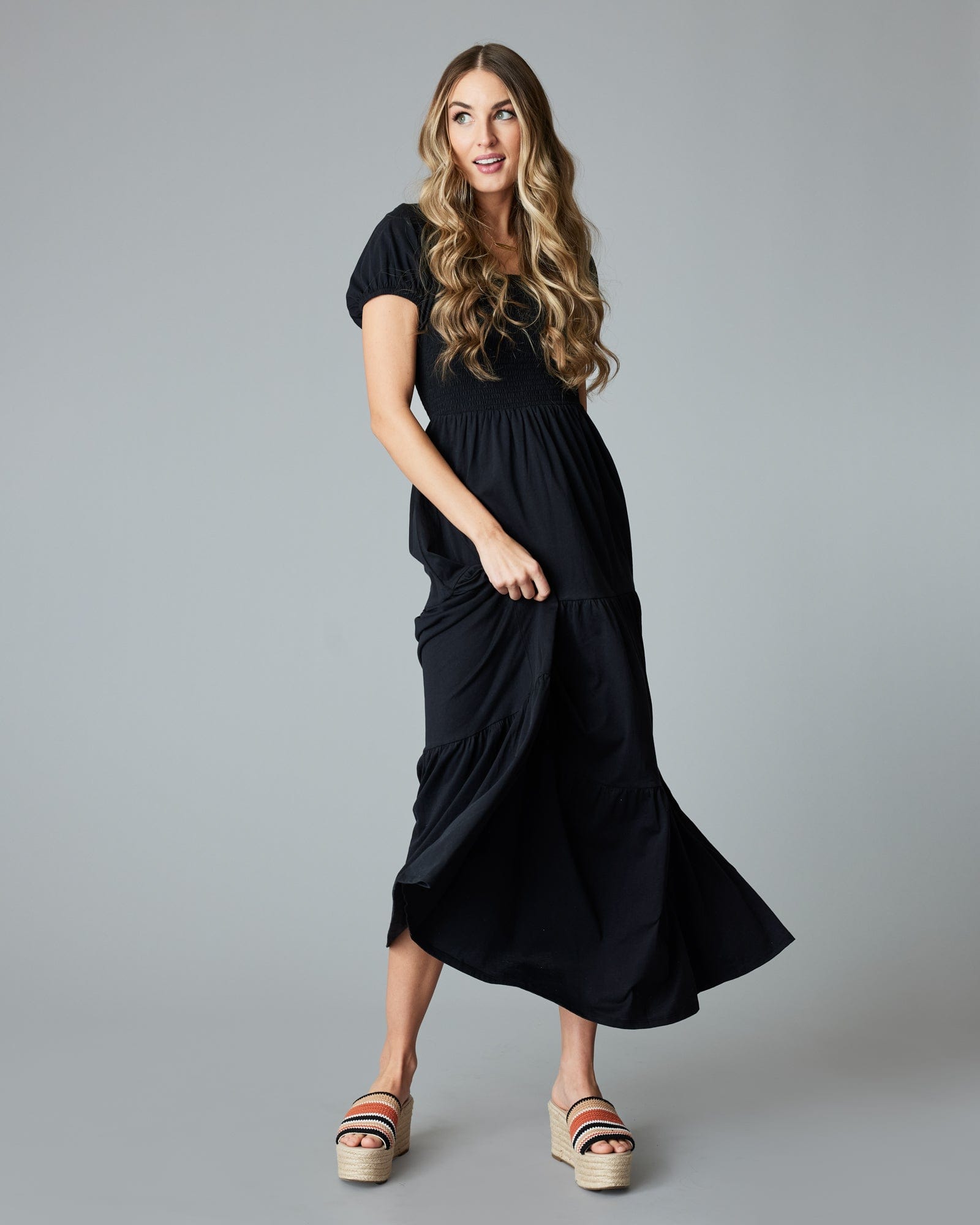 Woman in a black, short sleeved, maxi dress