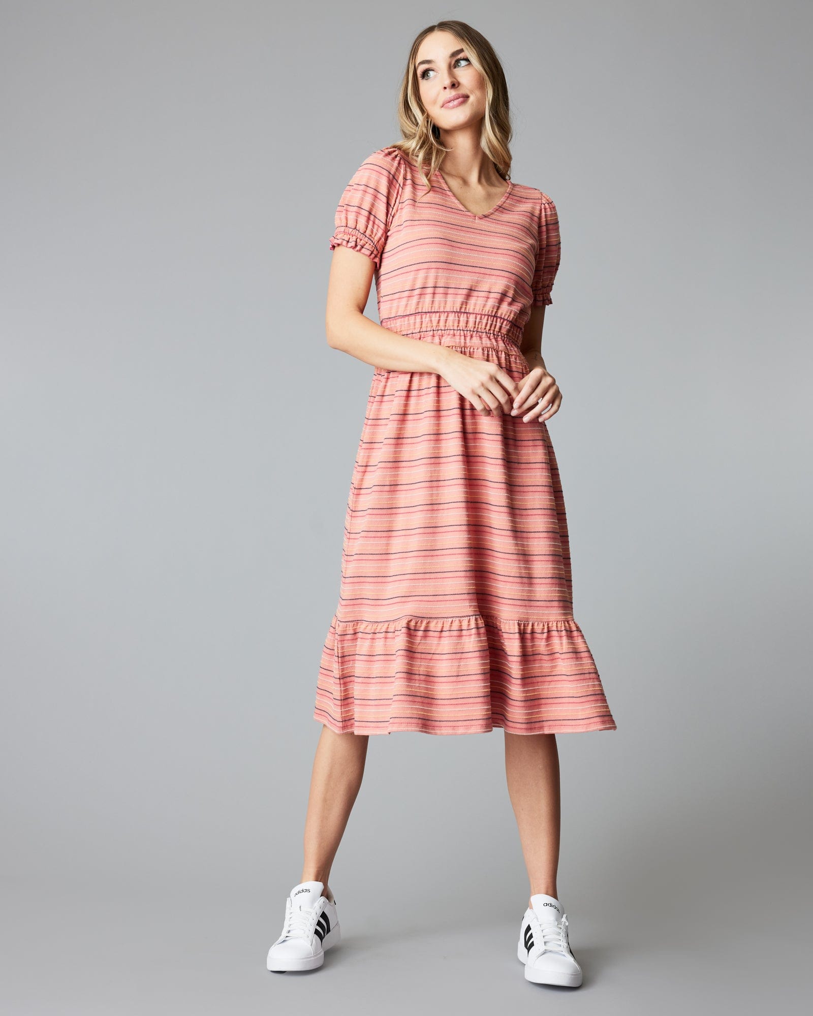 Woman in a short sleeve, striped, pink, midi-length dress