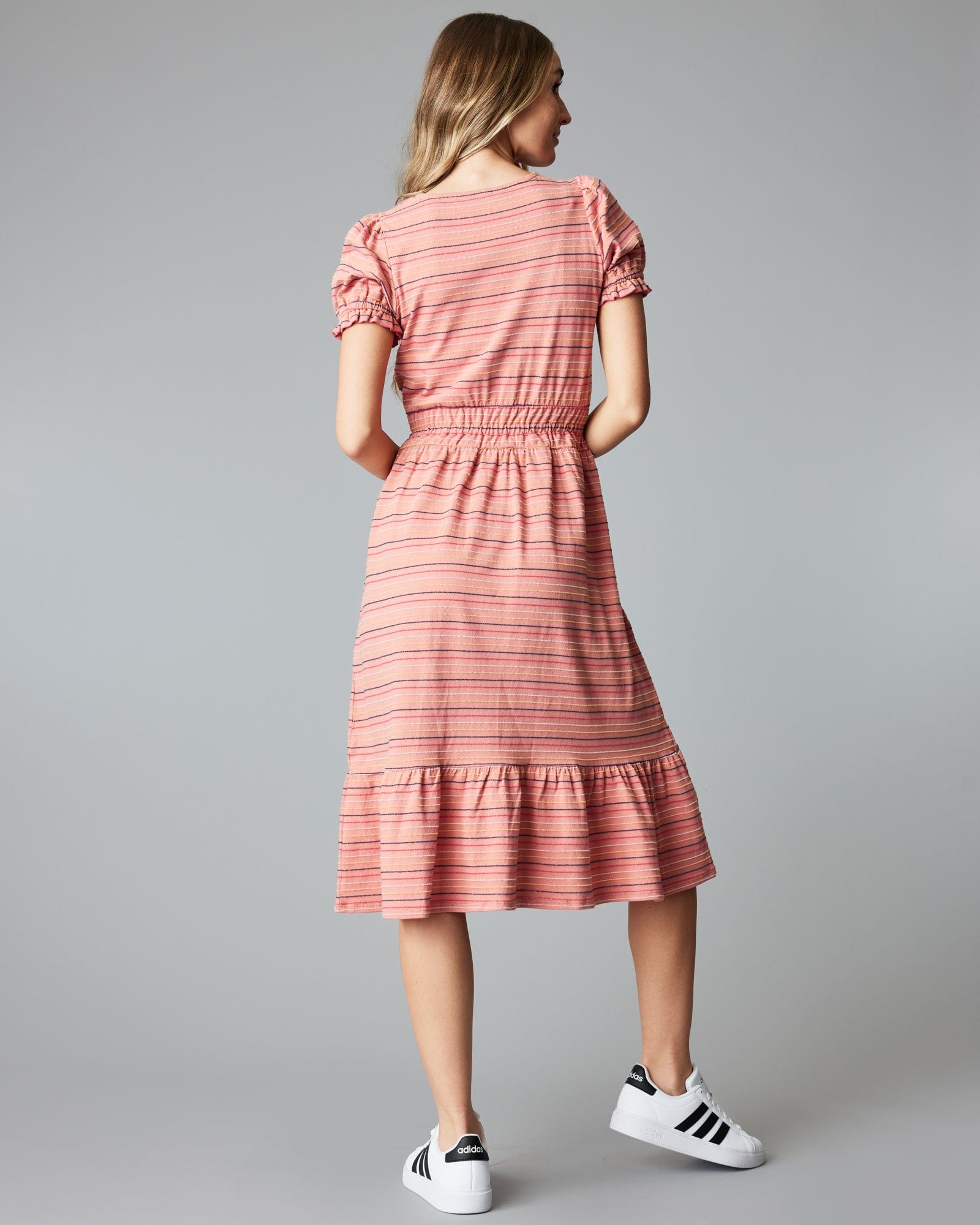 Woman in a short sleeve, striped, pink, midi-length dress