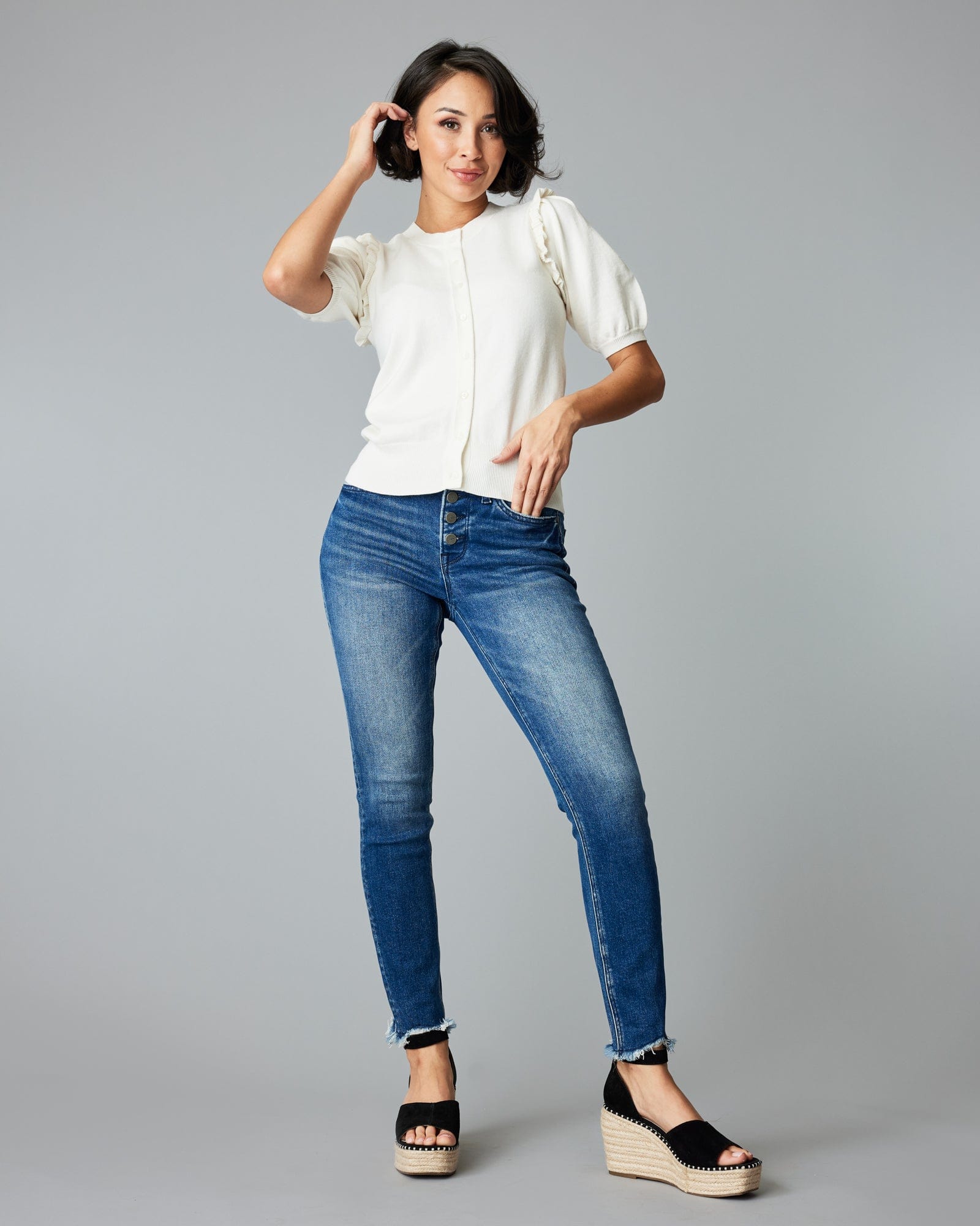 Woman in a short sleeve white cardigan.