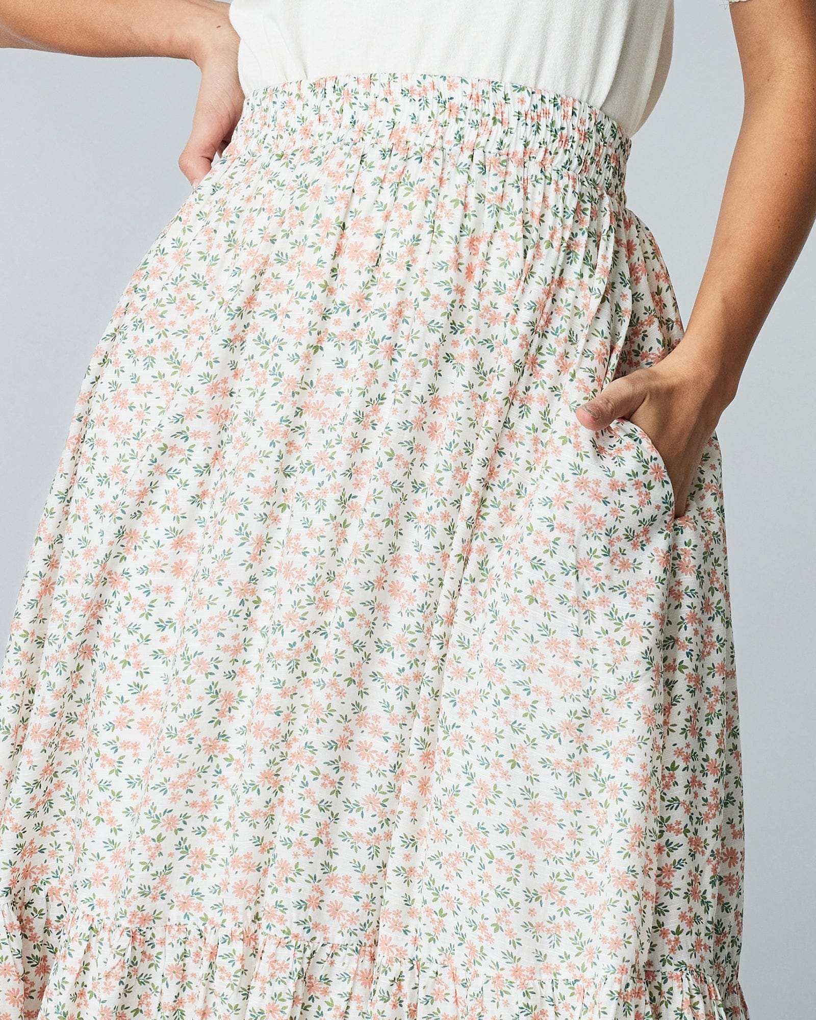 Woman in a maxi length, floral printed skirt