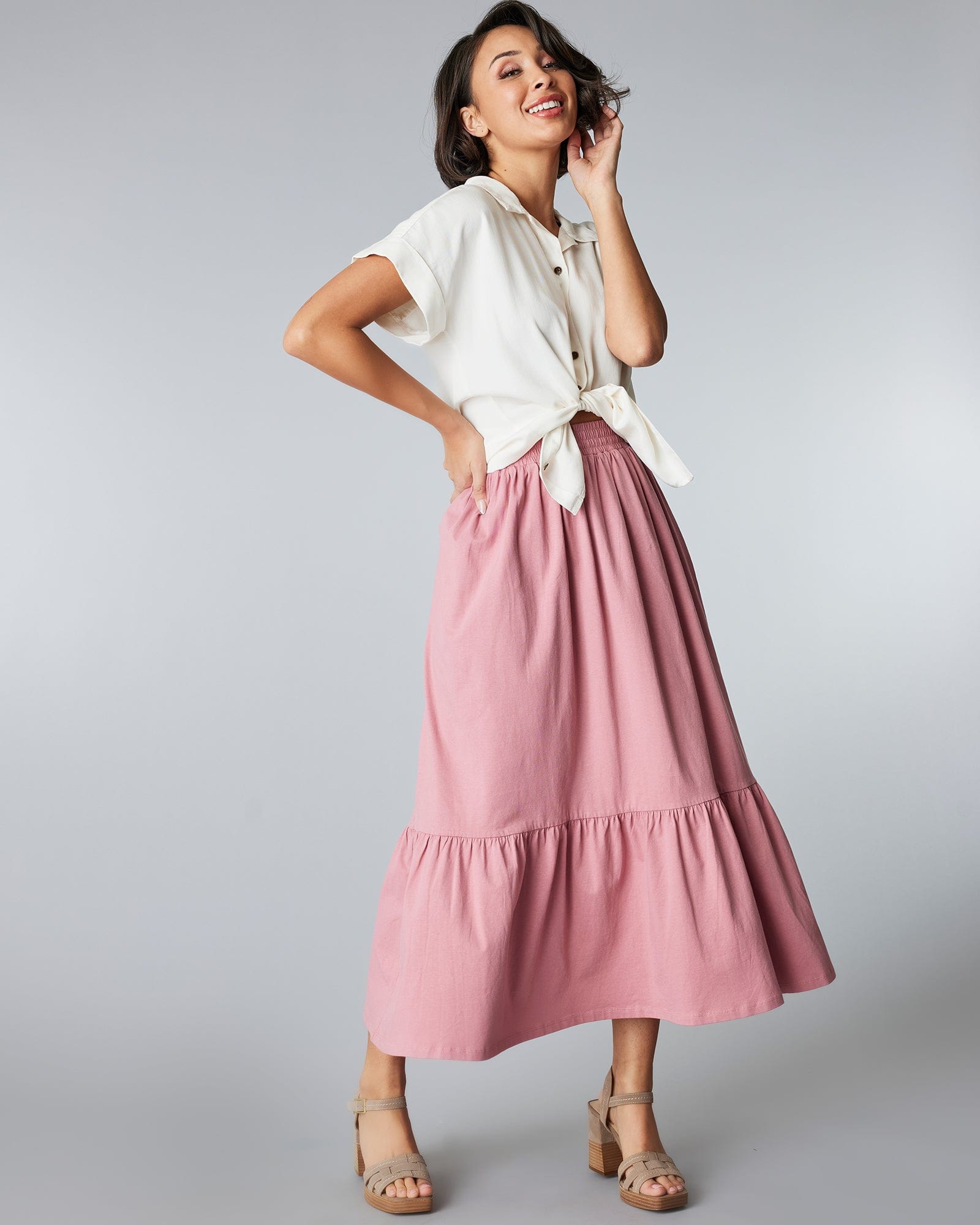 Woman in a pink, tiered, midi skirt