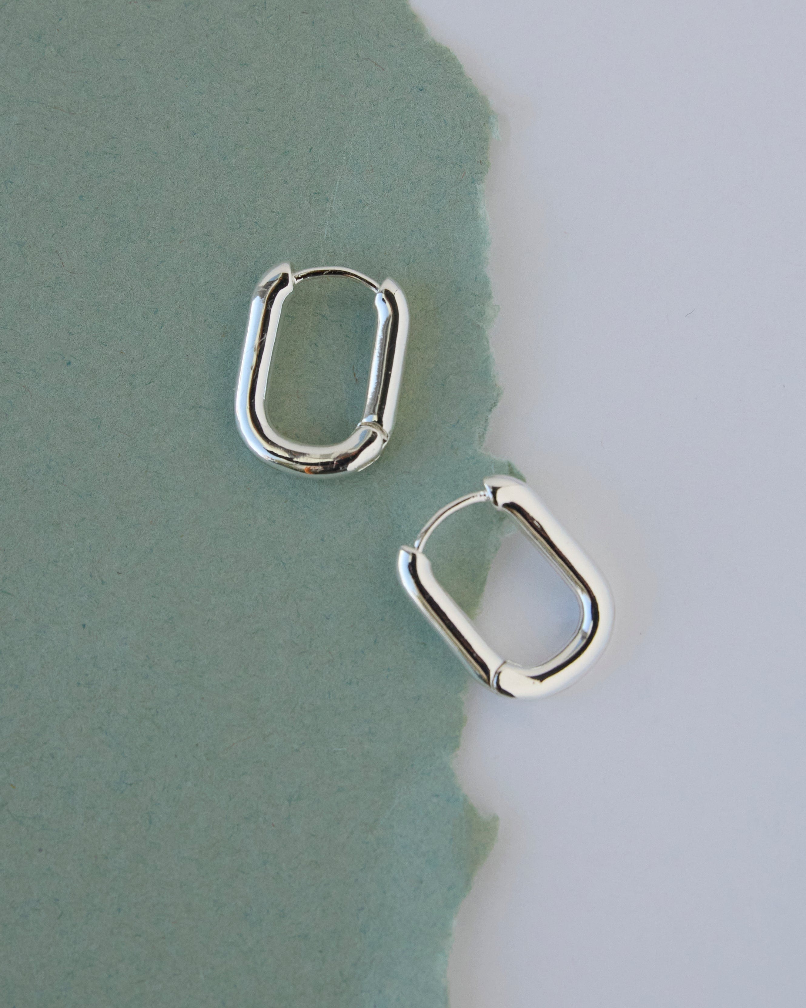 Silver curved hoop earrings.