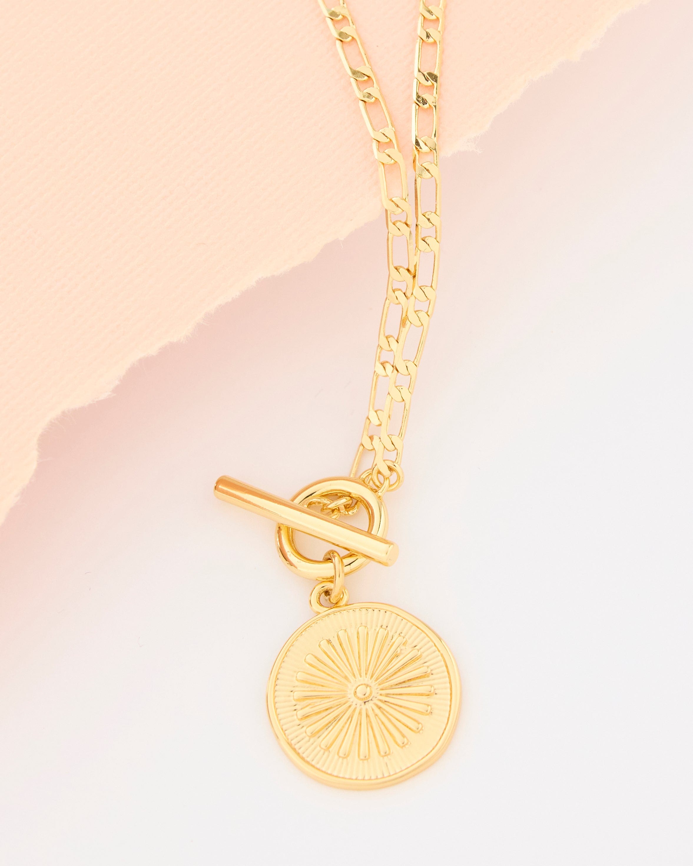 Gold necklace with flower charm.