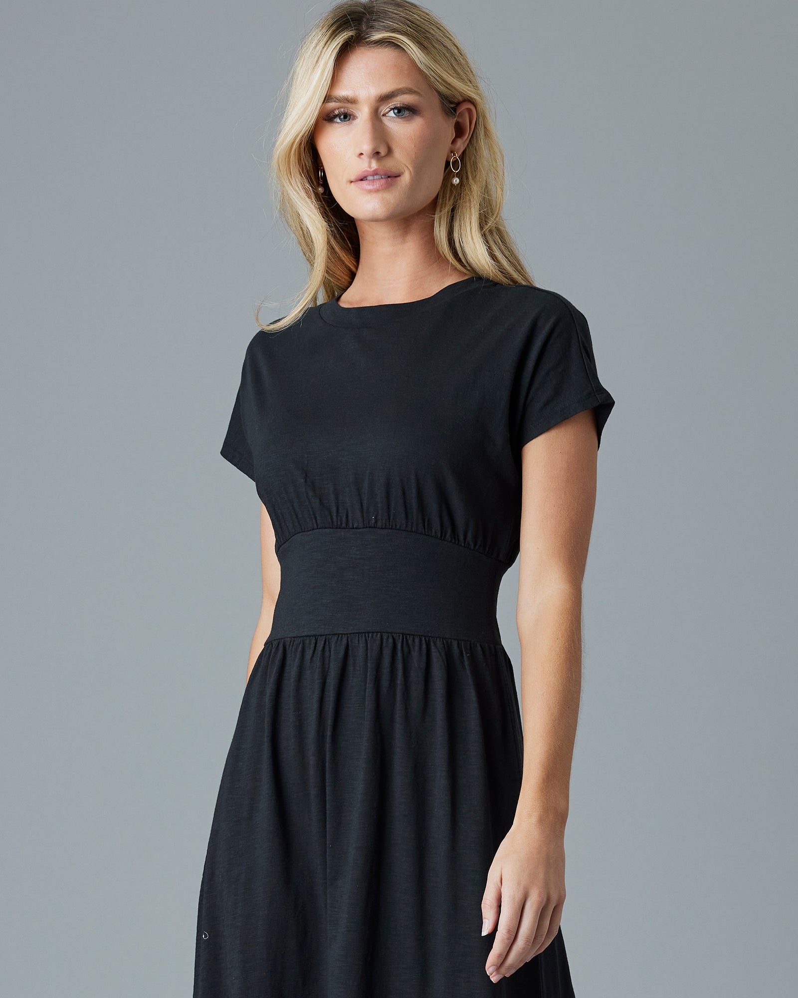 Woman in a black, short sleeve, midi dress