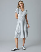 Woman in a grey short sleeve midi dress
