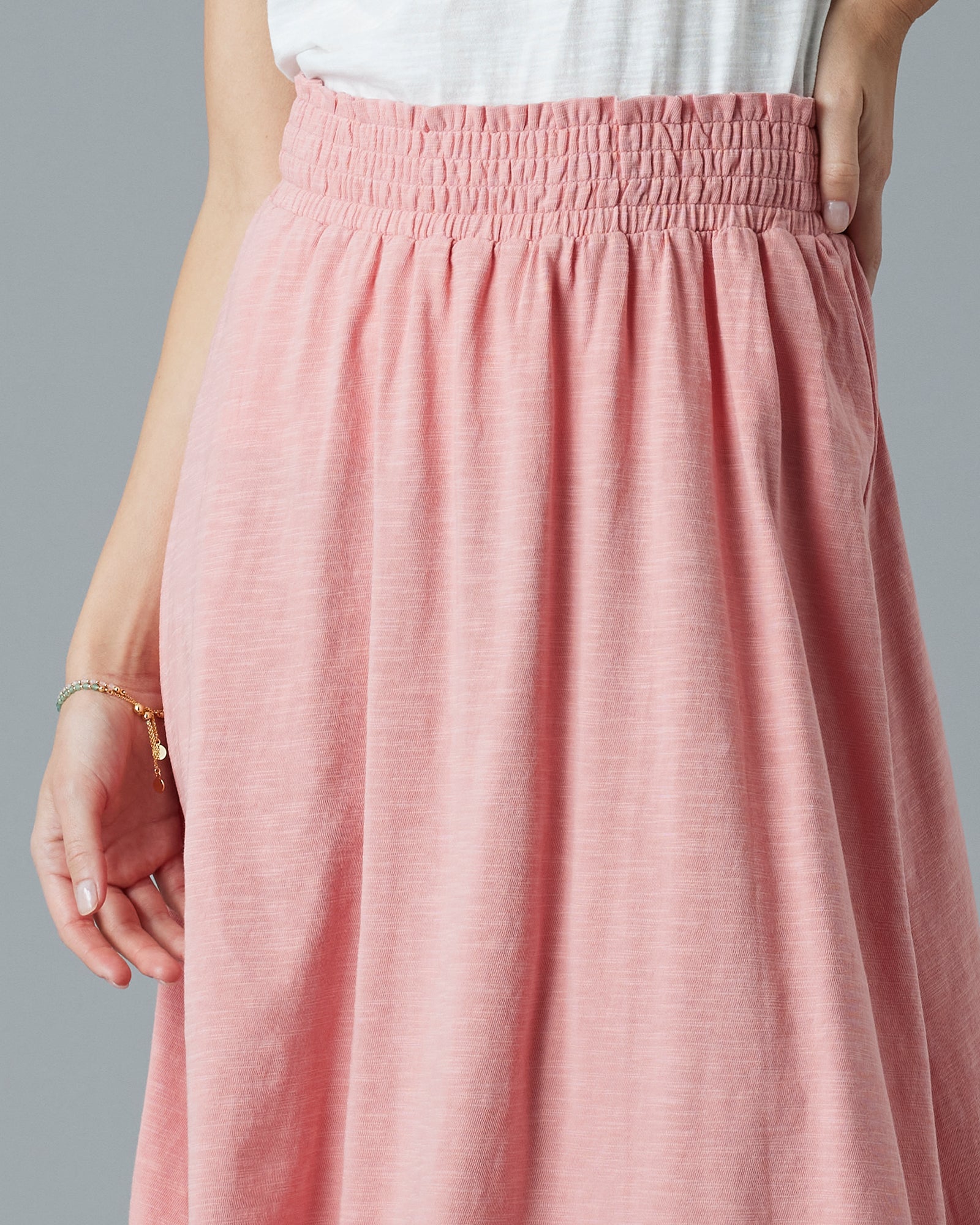 Woman in a pink midi-length dress