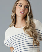 Woman in a cream with navy striped short sleeve sweater