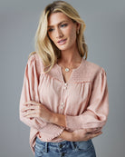 Woman in a pink 3/4 sleeve blouse