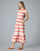 Woman in a pink and white striped a-line t-shirt dress