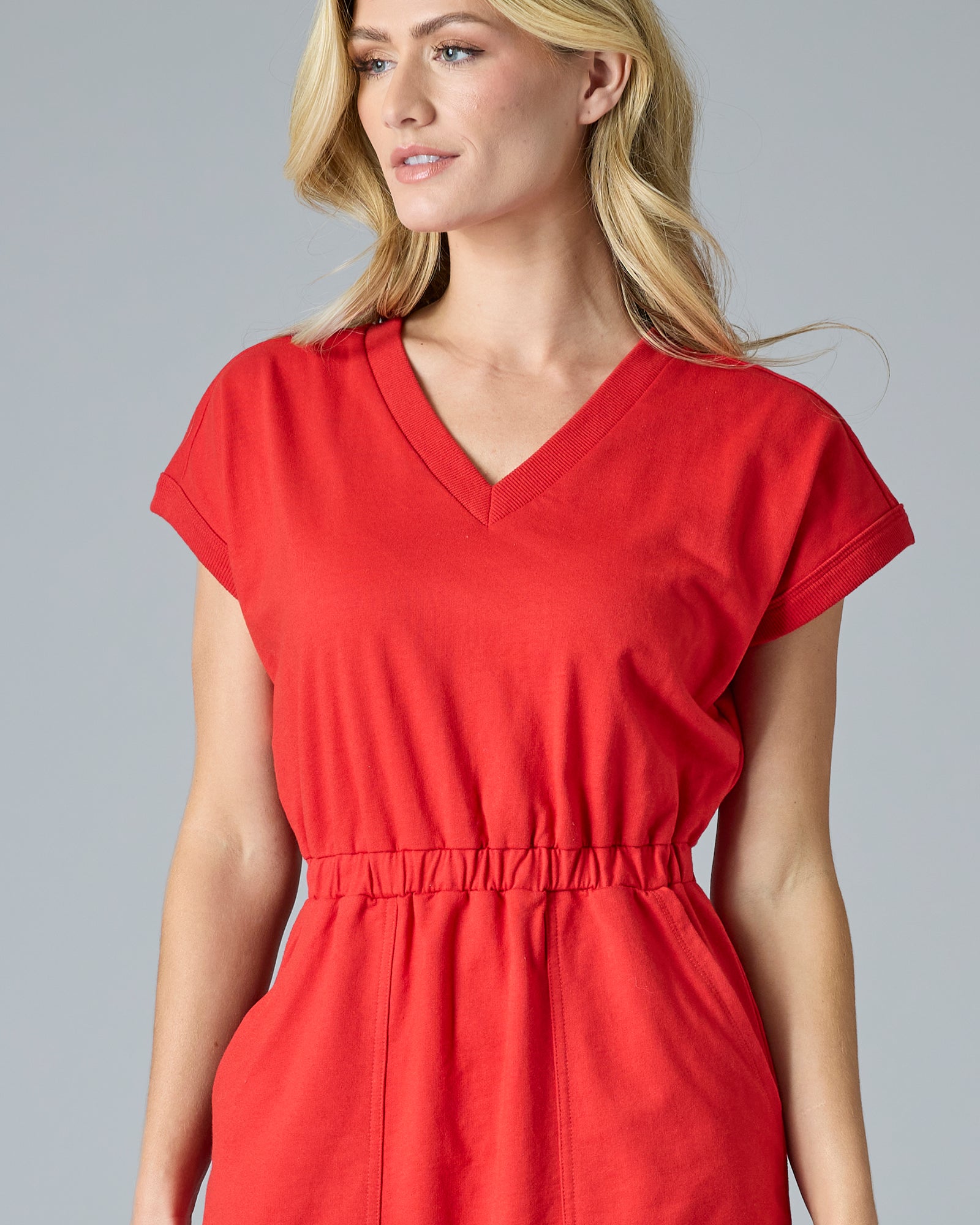 Woman in red short sleeve, knee-length dress with pockets
