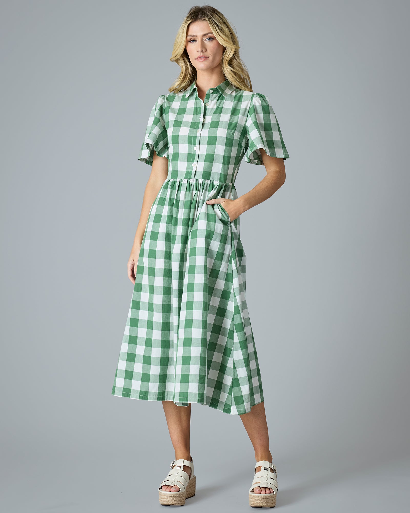 Woman in a plaid green short sleeve midi-length dress