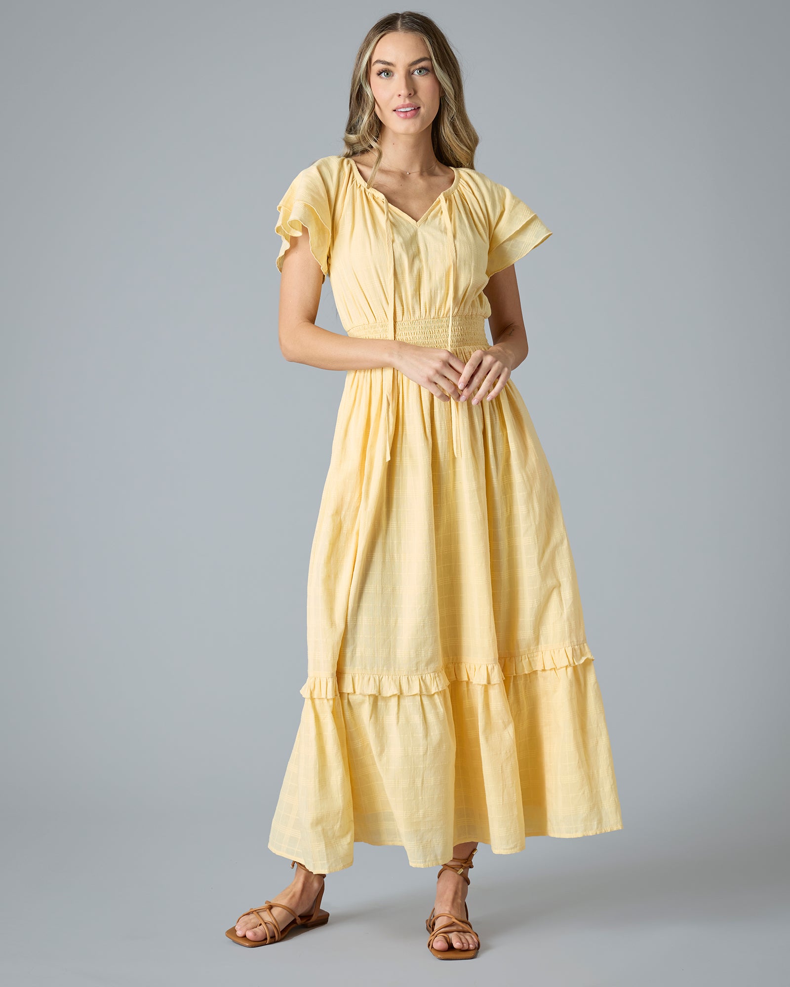 Woman in a yellow short sleeve, maxi length dress