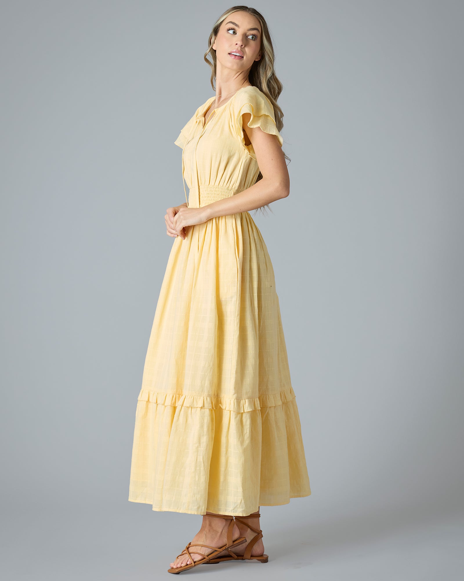 Woman in a yellow short sleeve, maxi length dress