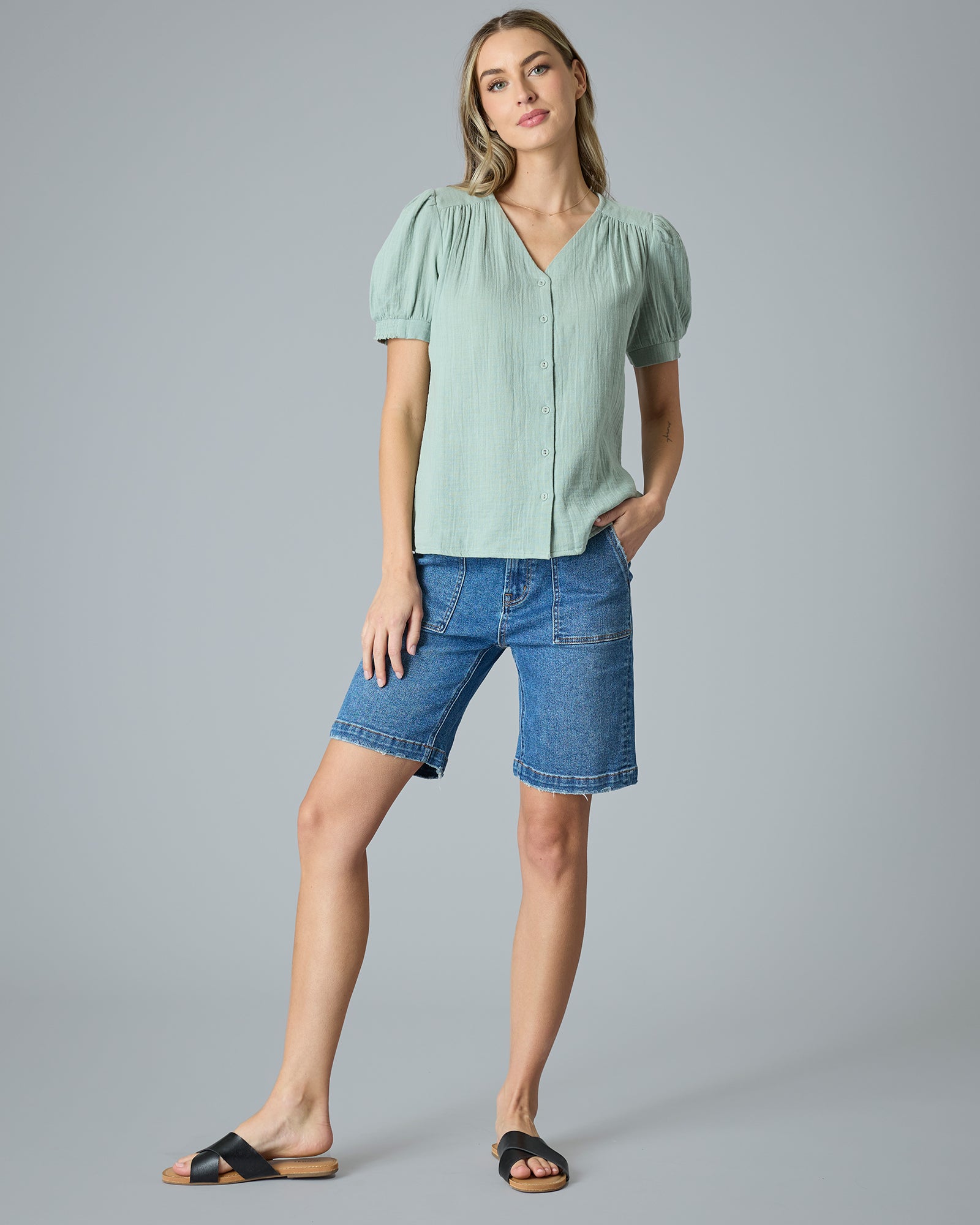 Woman in a green short sleeve button-down blouse