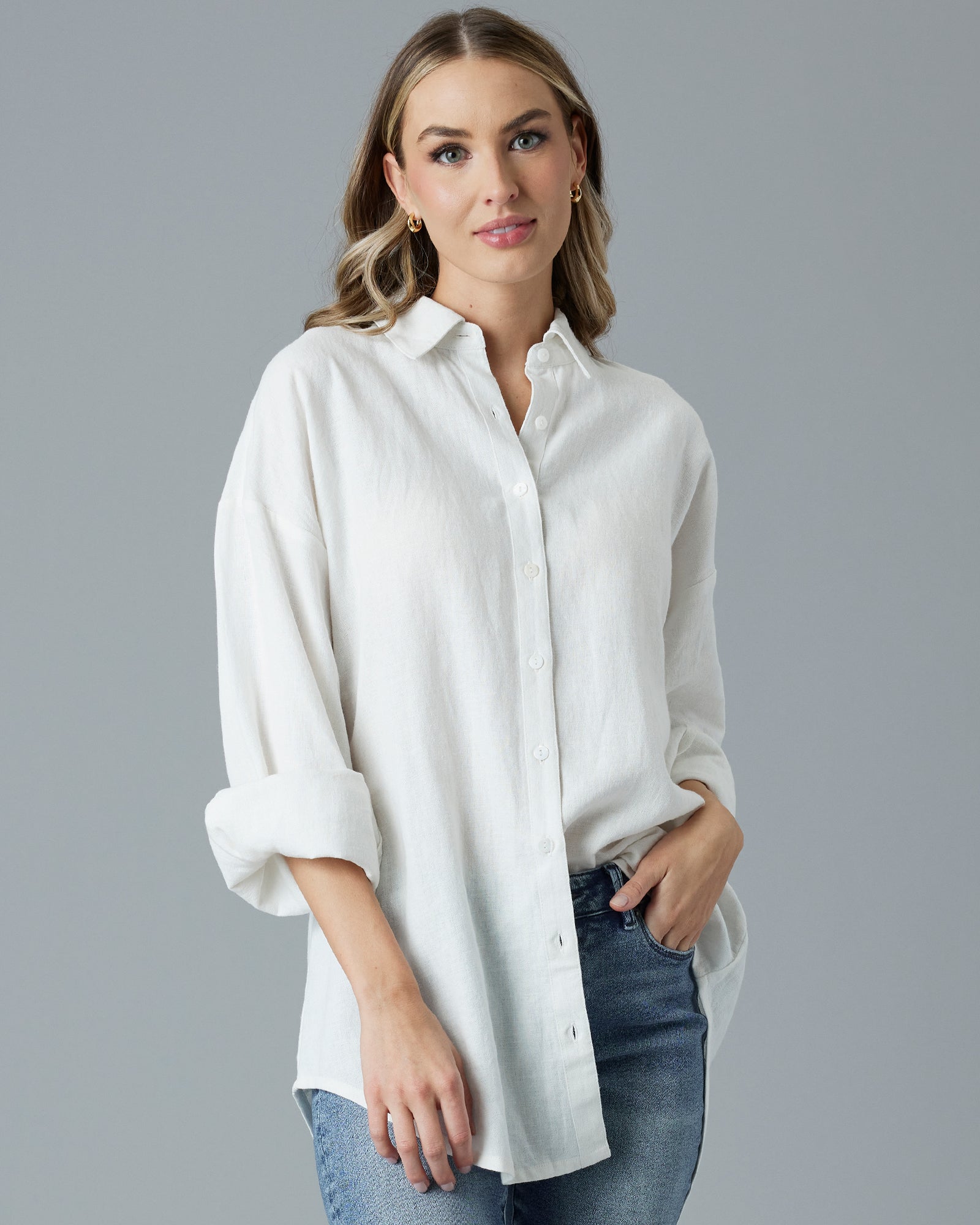 Woman in a white, over-sized, long sleeve buttondown