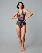 Woman in a one-piece floral printed swimsuit.