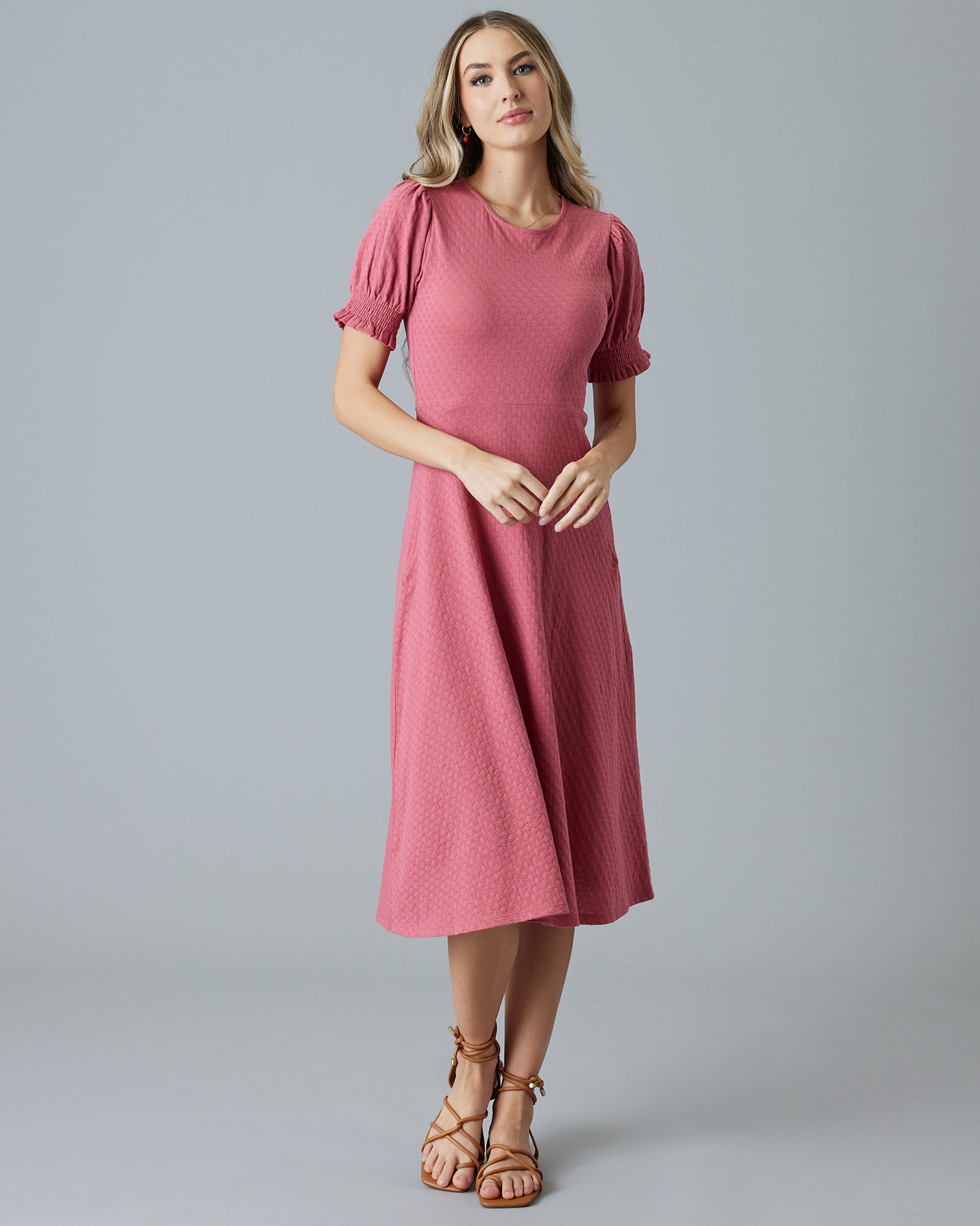 Woman in a pink short sleeve, midi-dress