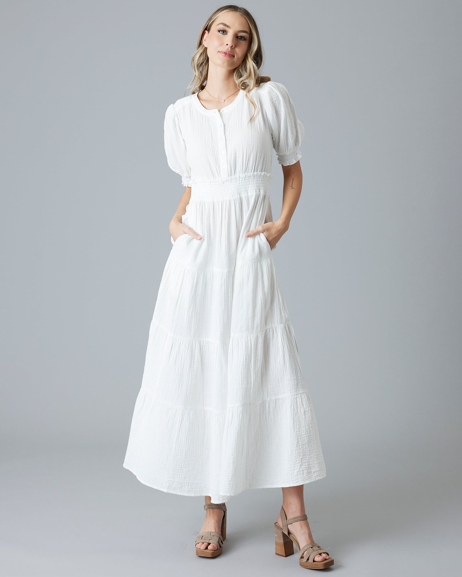 Woman in a white short sleeve maxi-length dress