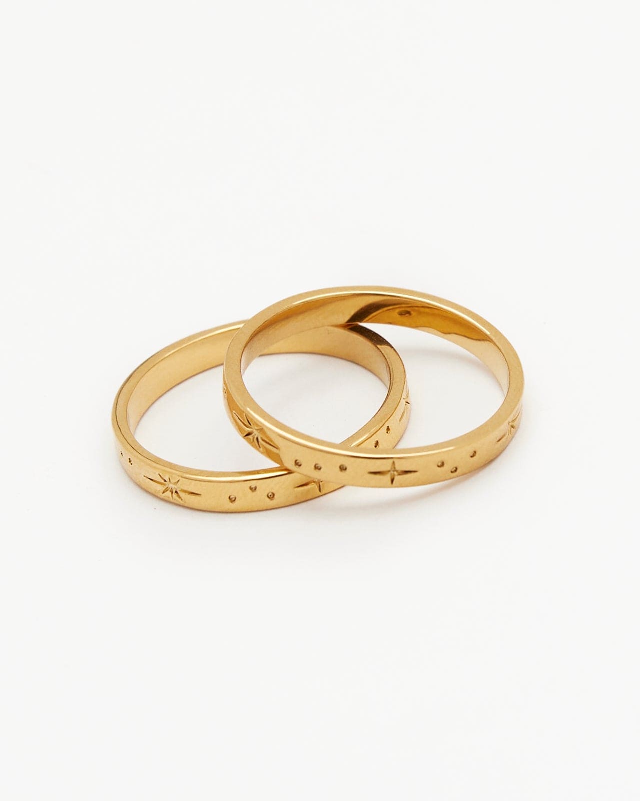 Two gold rings with constellations on them