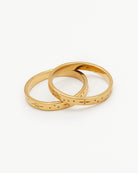 Two gold rings with constellations on them