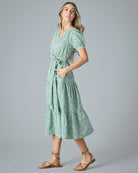 Woman in a green floral midi-length short sleeve dress