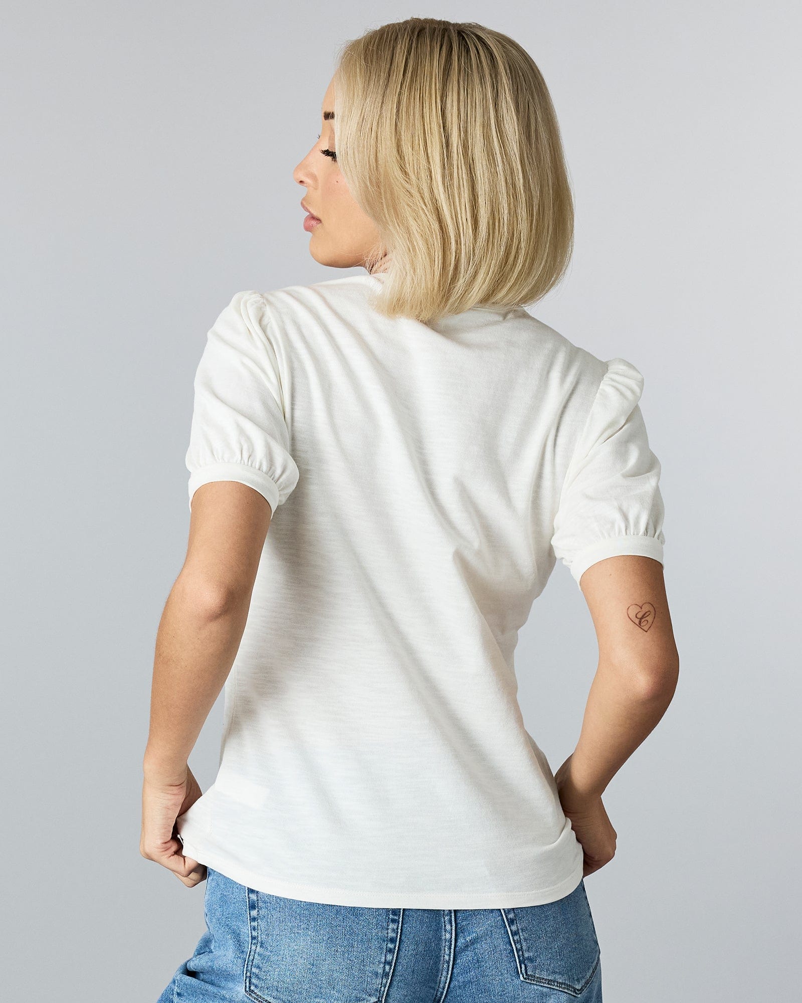 Woman in a short sleeved t-shirt.