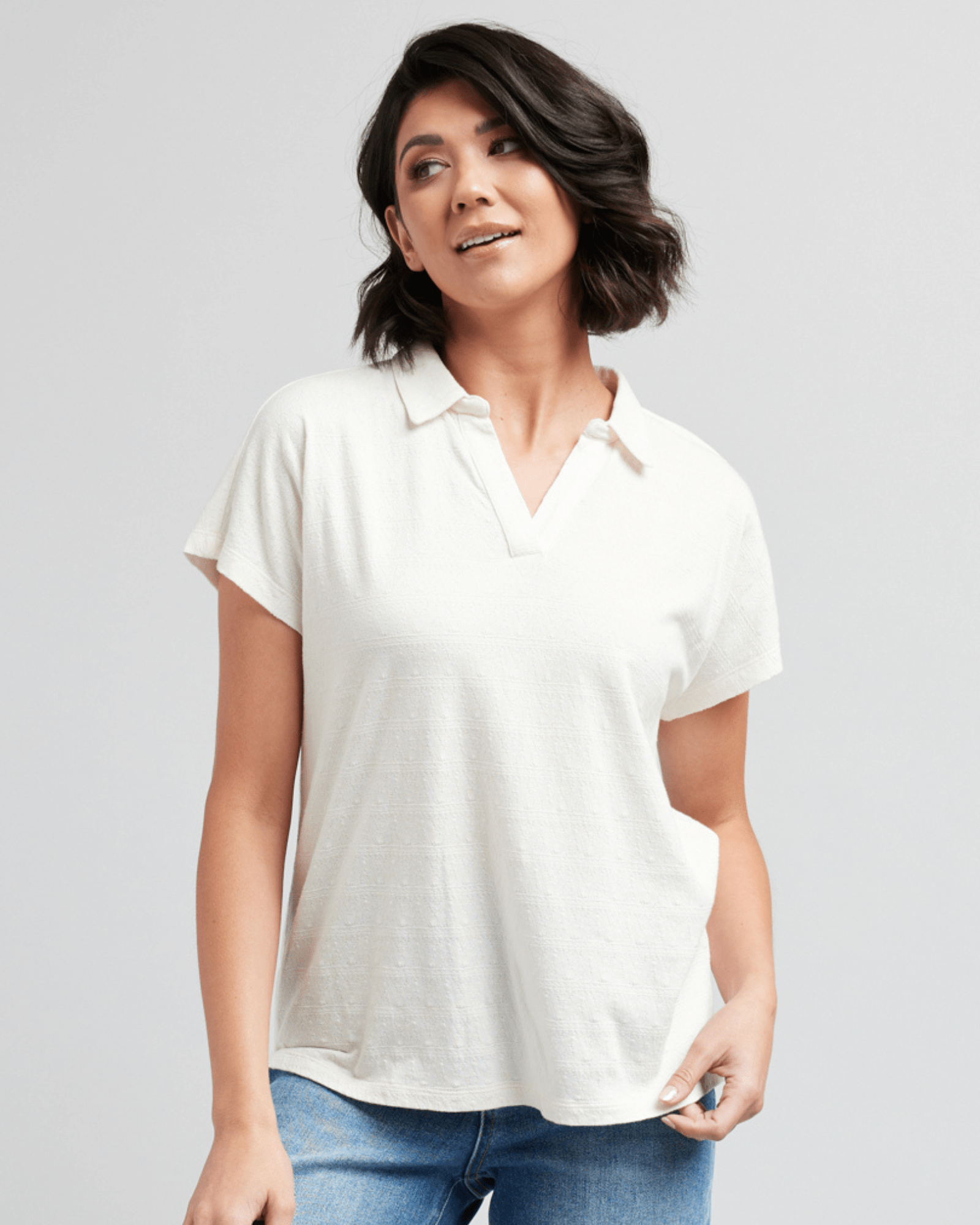 Woman in a short sleeve, collared, white blouse