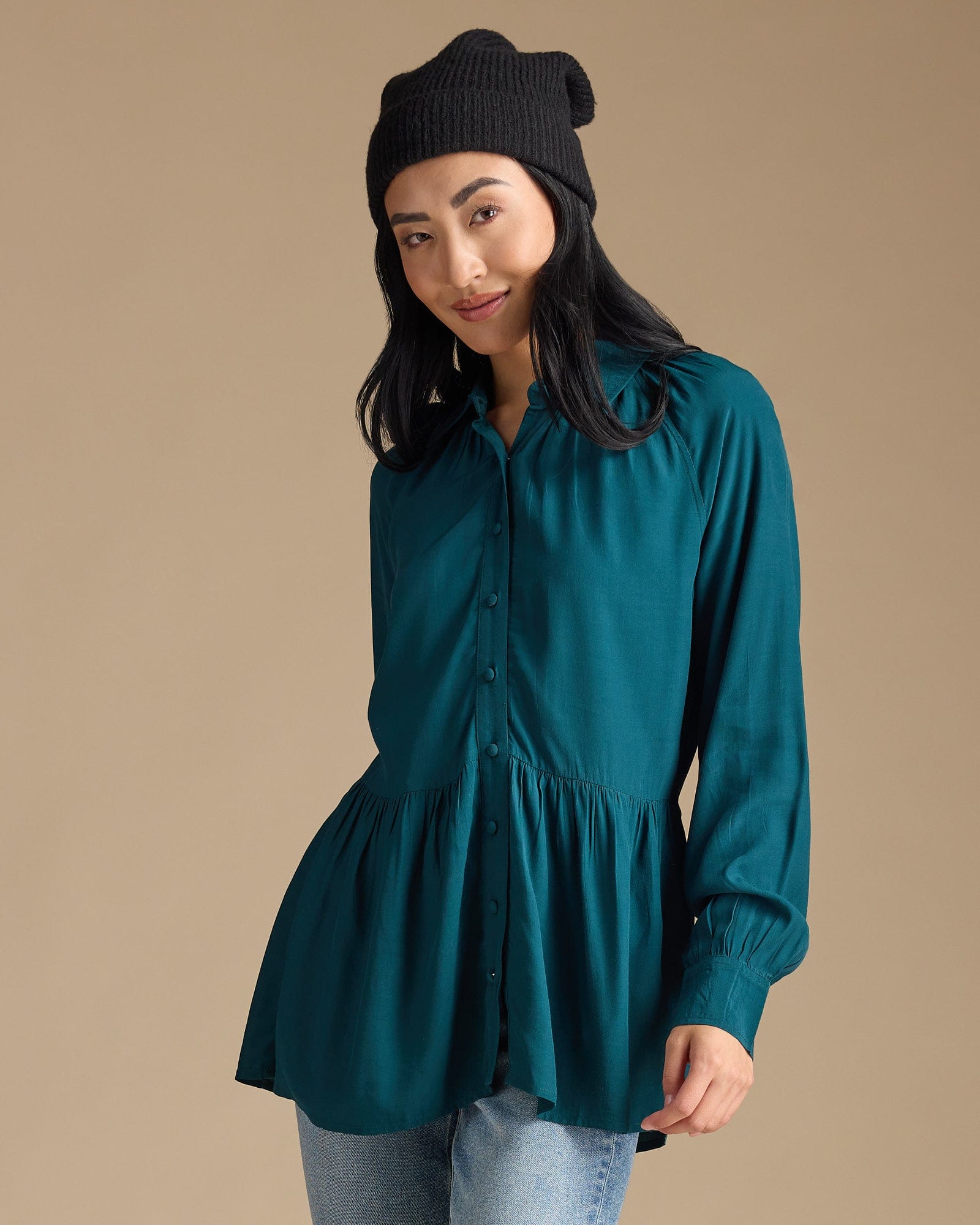 Woman in a teal button-down peplum top