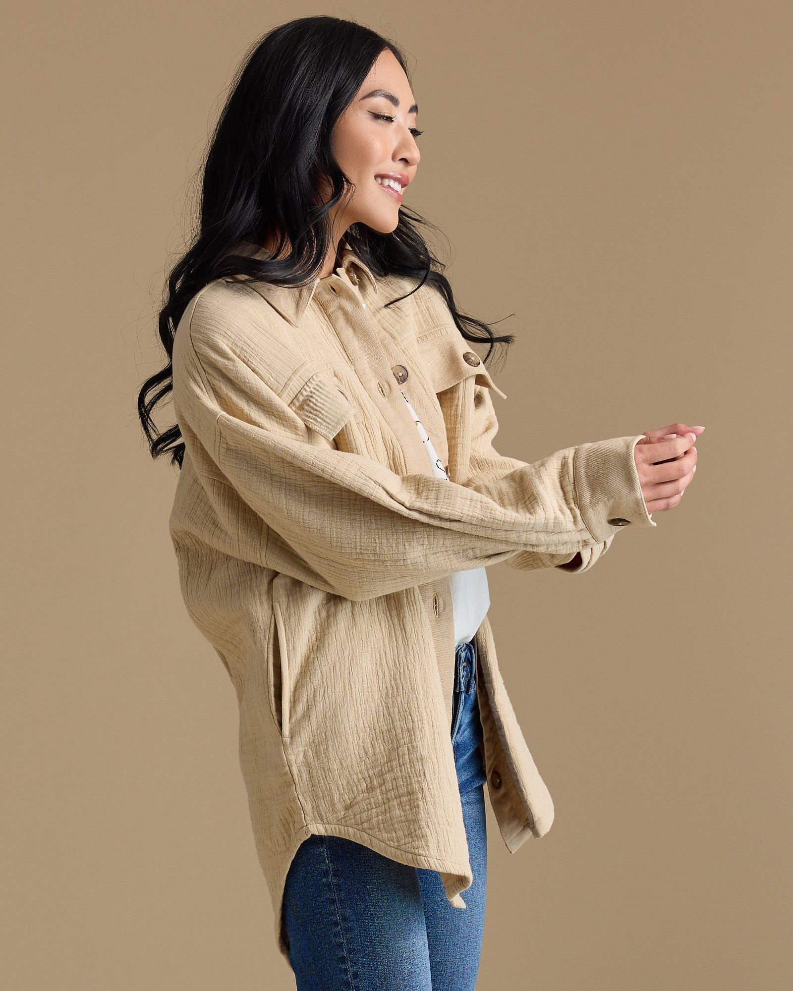 Woman in tan long sleeved textured jacket