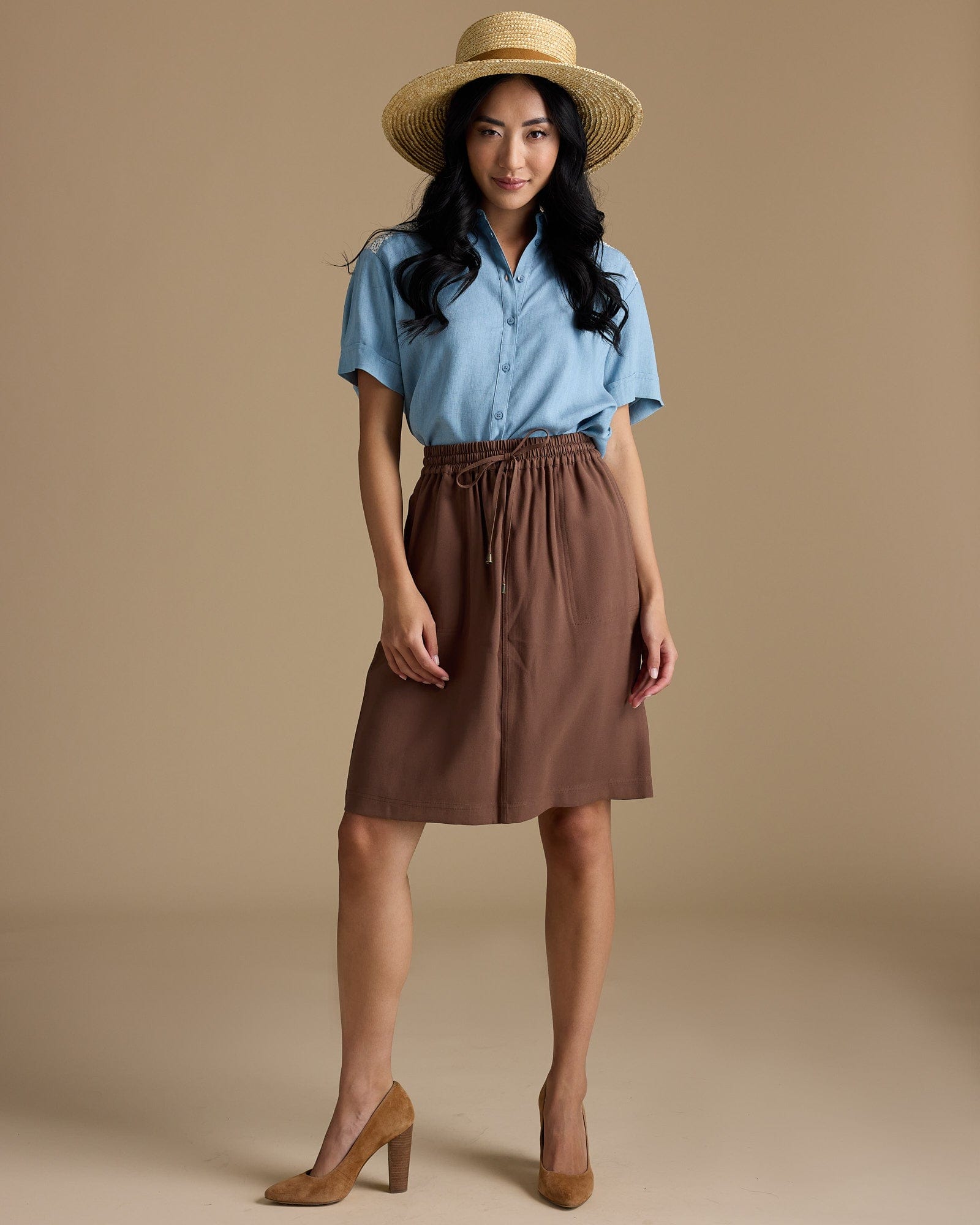 Woman in brown, knee-length skirt