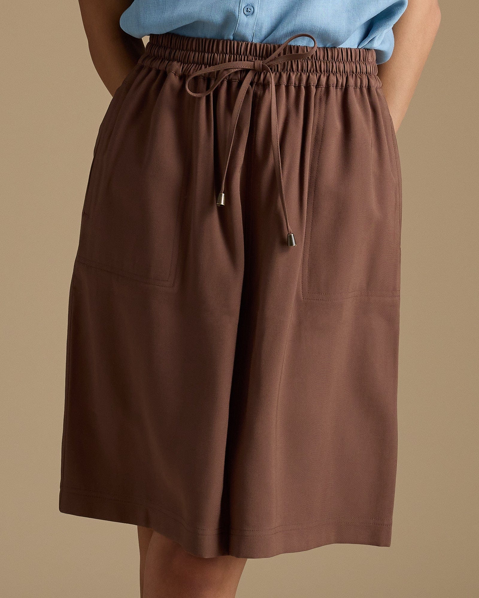 Woman in brown, knee-length skirt