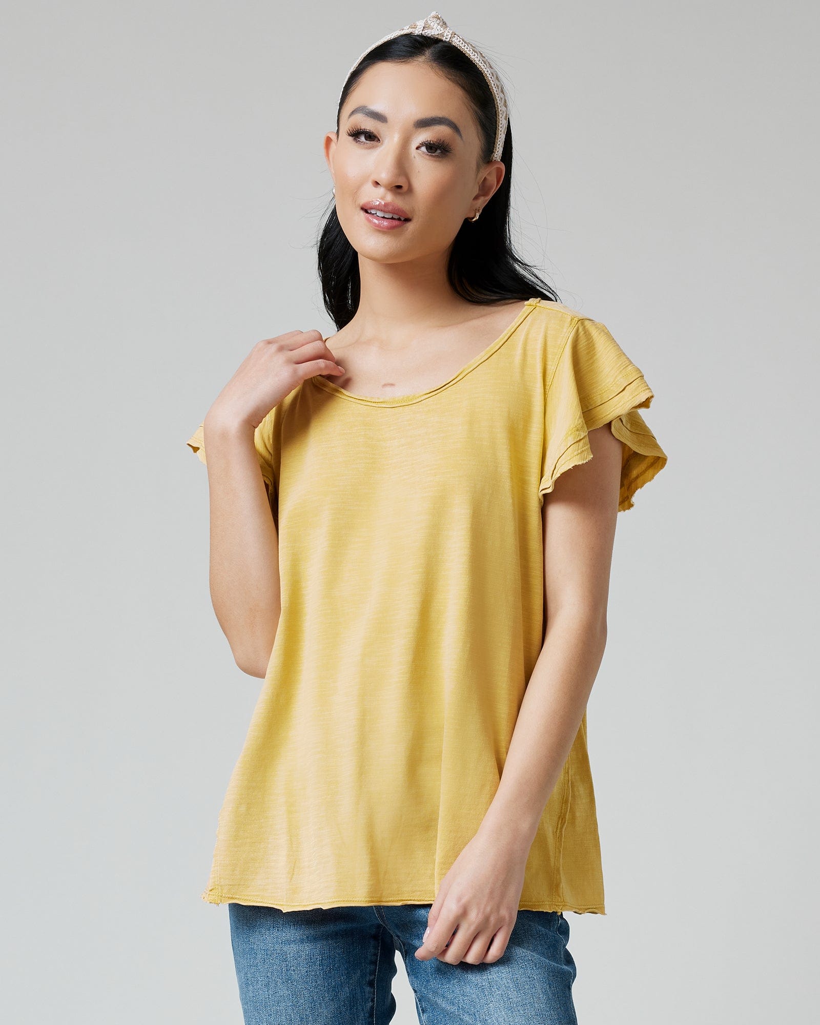 Woman in a top with short, flutter sleeves