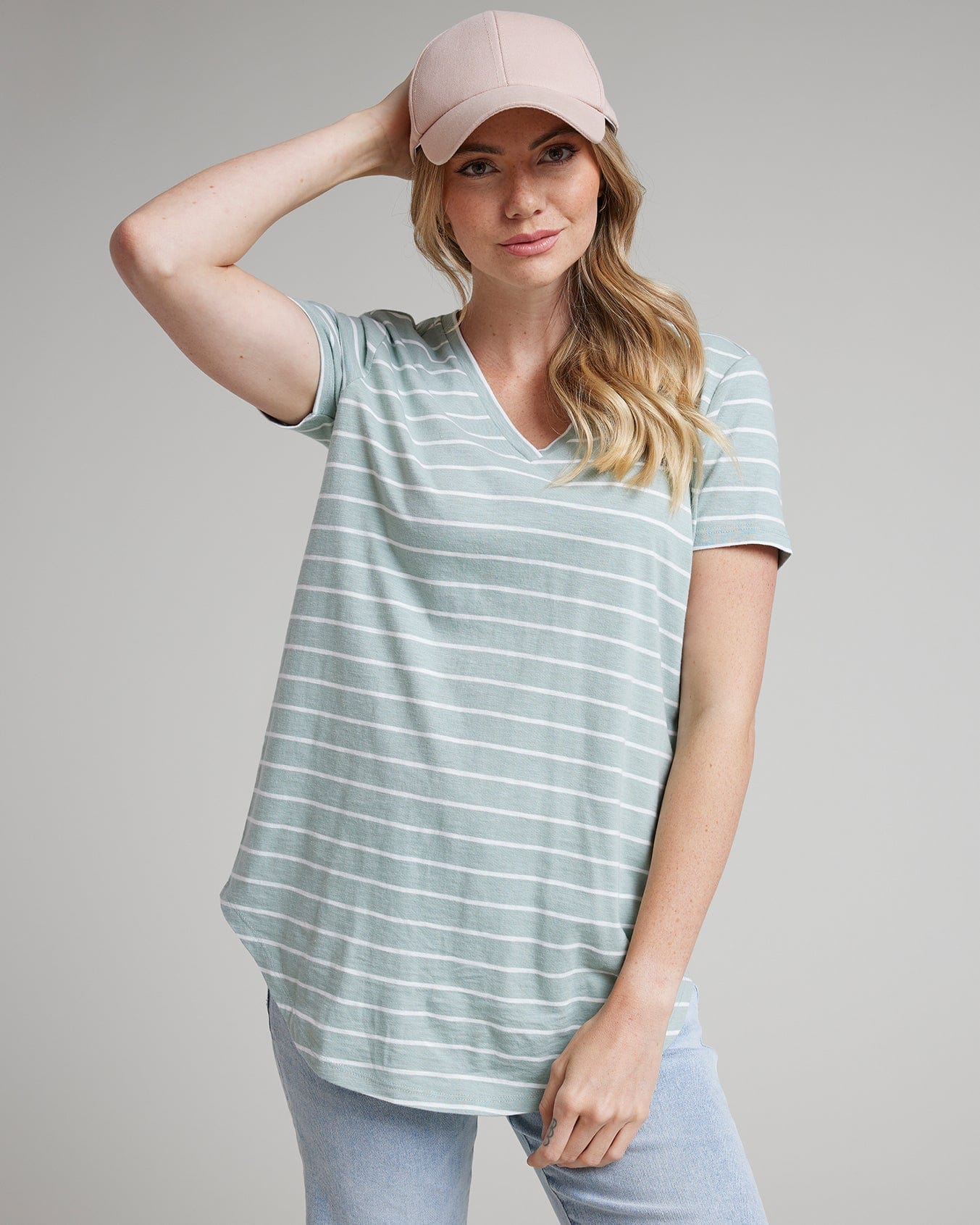 Woman in a blue with white striped t-shirt with short sleeves and a v-neck