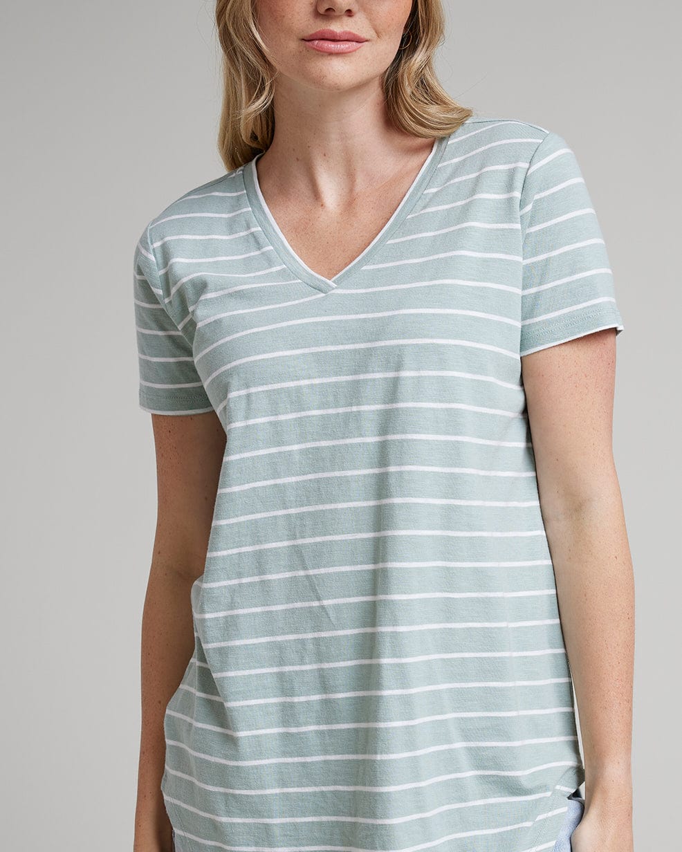 Woman in a blue with white striped t-shirt with short sleeves and a v-neck