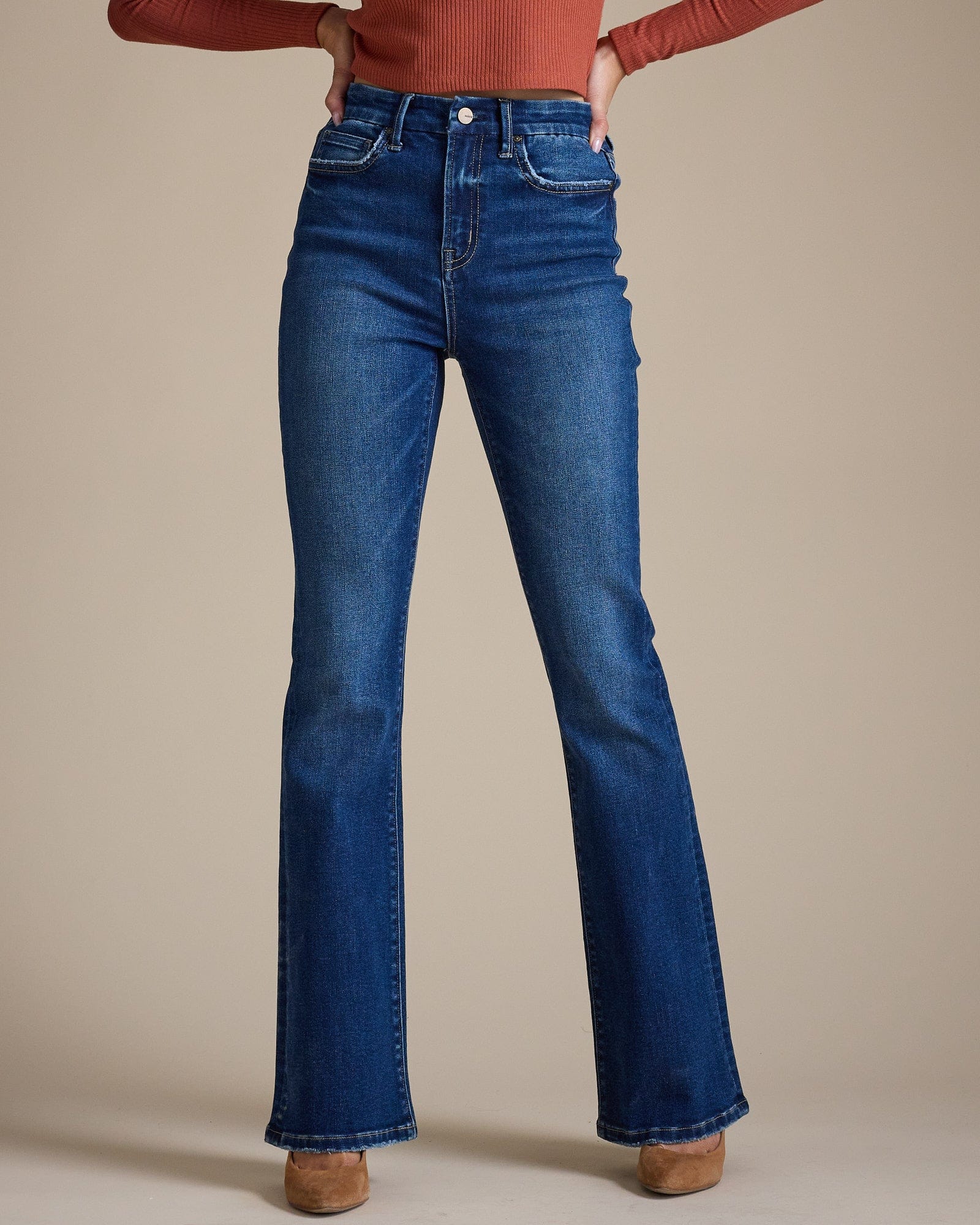 Woman in blue high-rise bootcut jeans