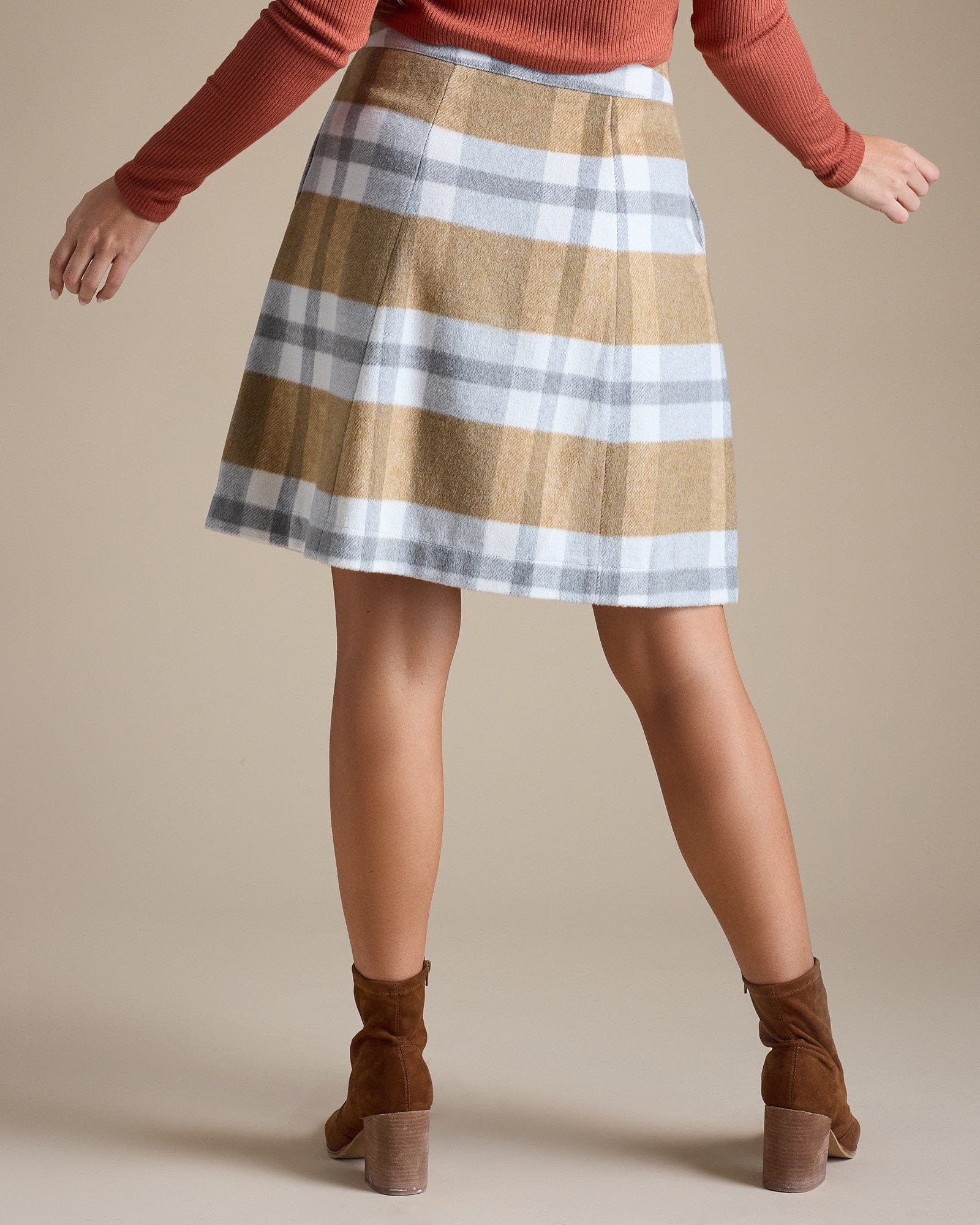 Woman in striped, knee-length, button-down skirt