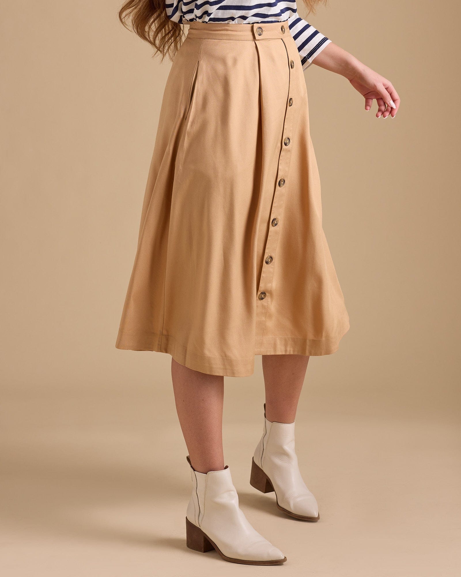 Woman in yellow midi-length button-down skirt