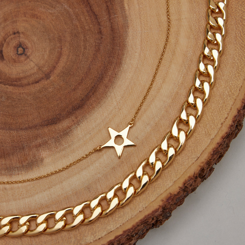A star layered necklaces on wood. Shop all accessories.