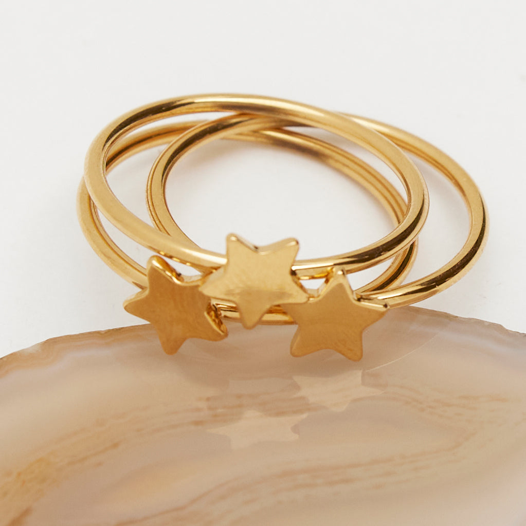 A three stack set of star rings. Shop Rings