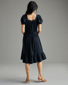 Womani n a short sleeve, square neckline, knee-length, black dress