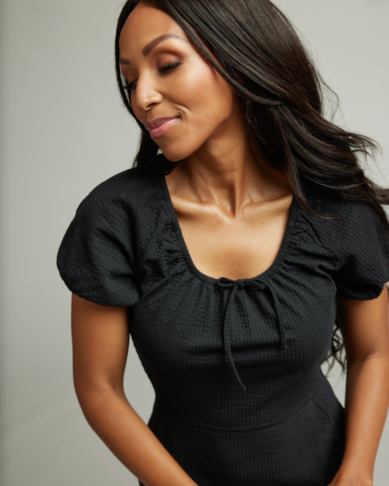 Woman in a short sleeve, knee-length, black dress