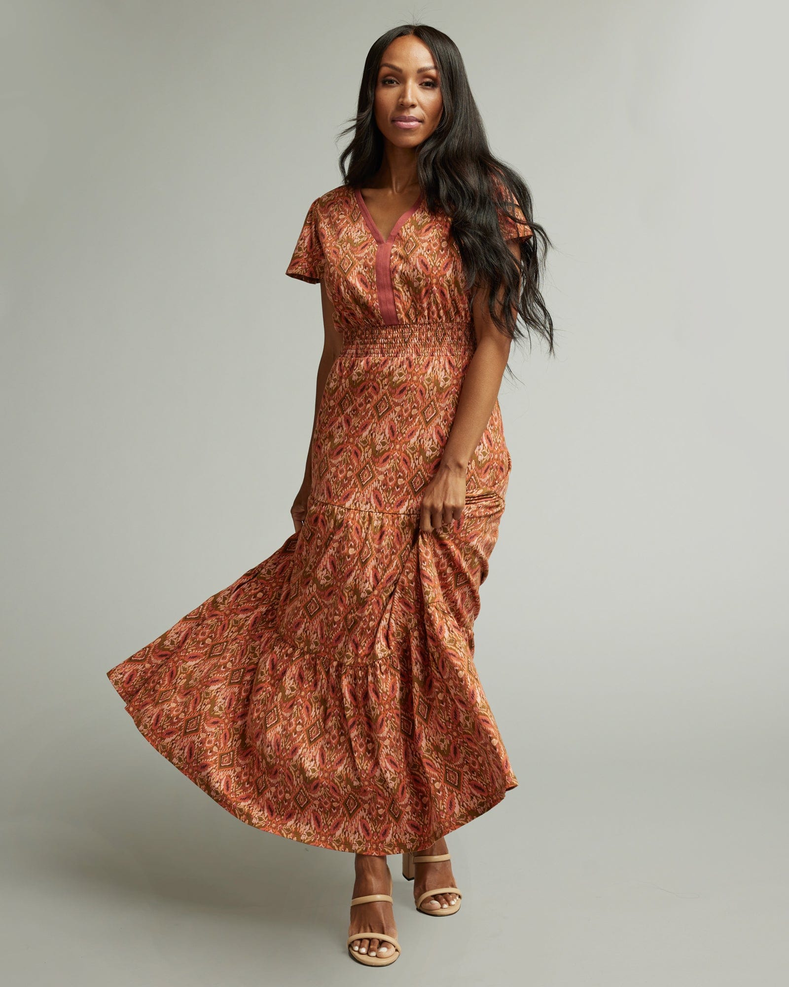 Woman in a short sleeve, orange and brown, maxi dress