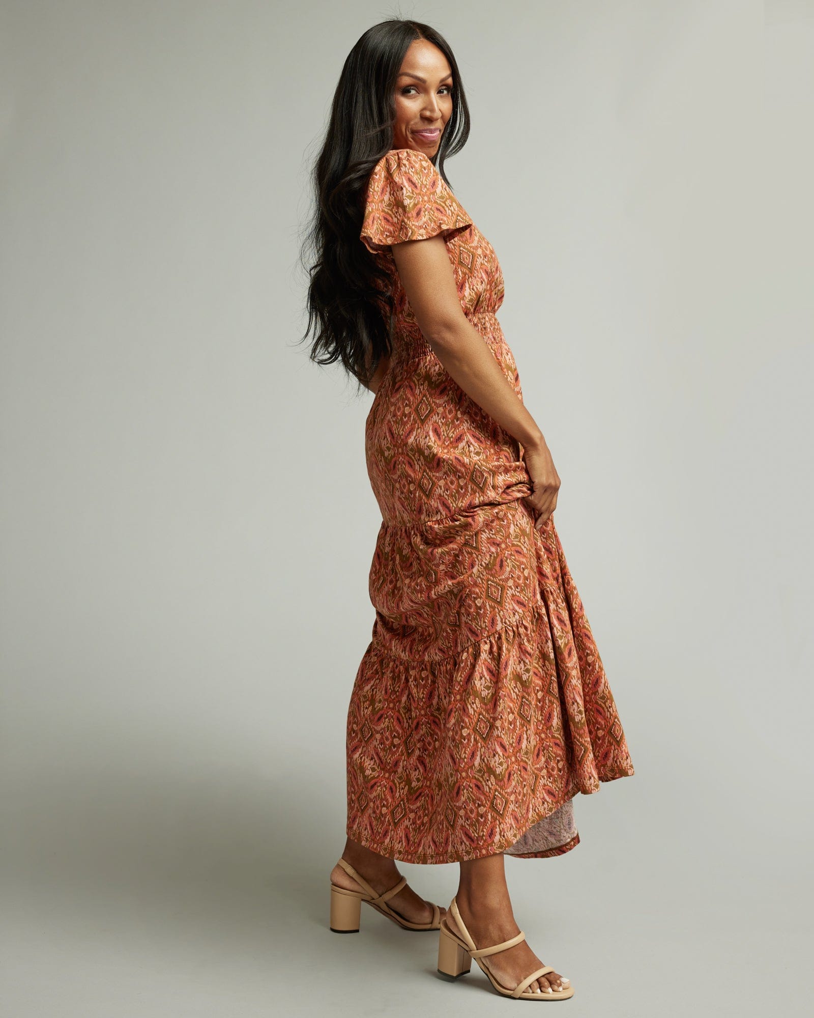 Woman in a short sleeve, orange and brown, maxi dress