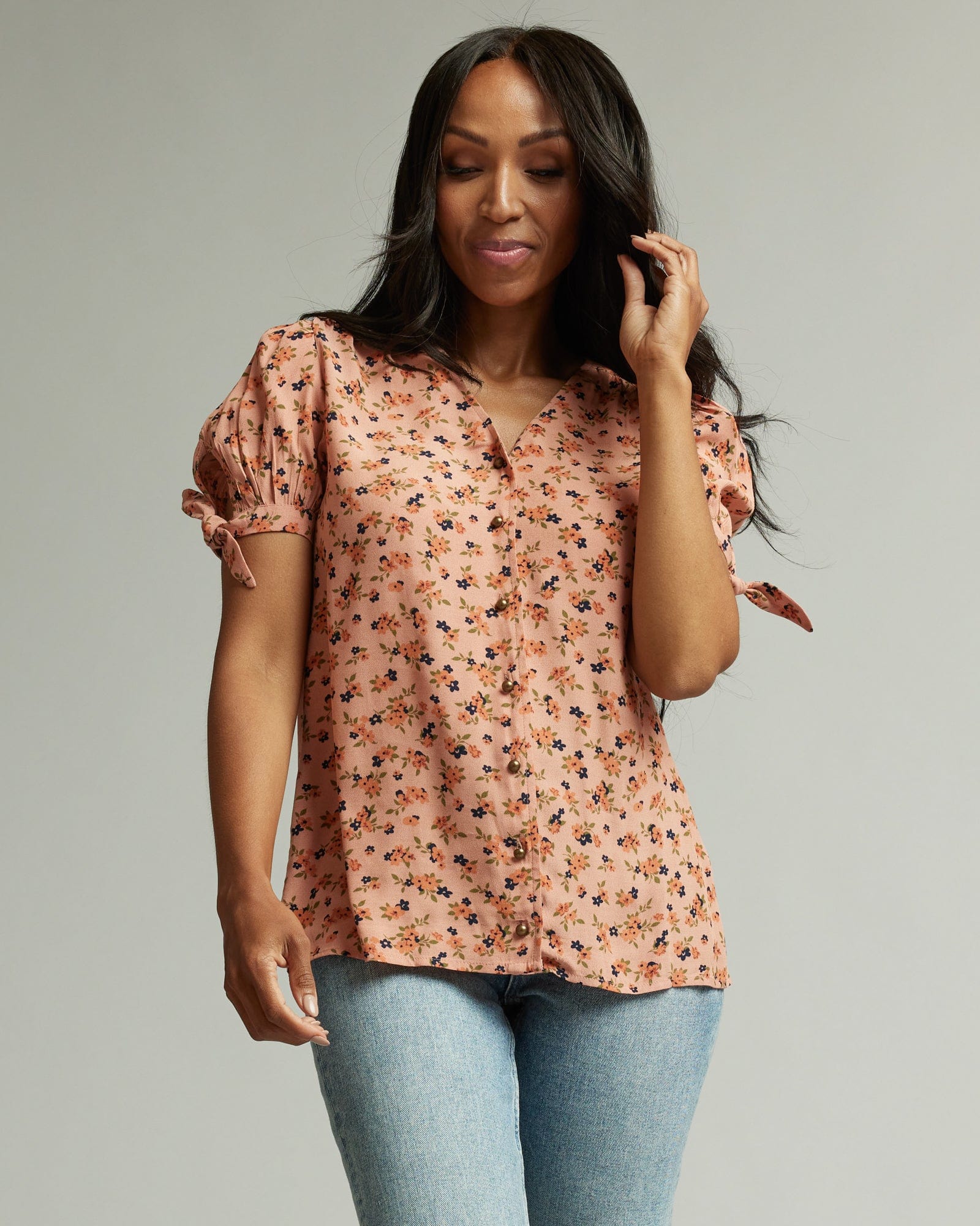 Woman in a short sleeve, pink floral print top