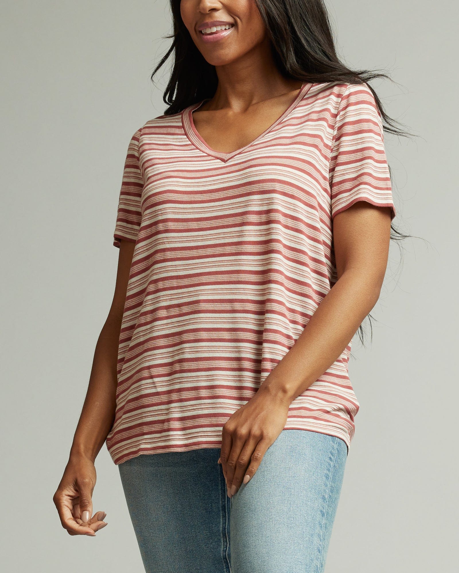 Woman in a short sleeve, v-neck, pink striped t-shirt